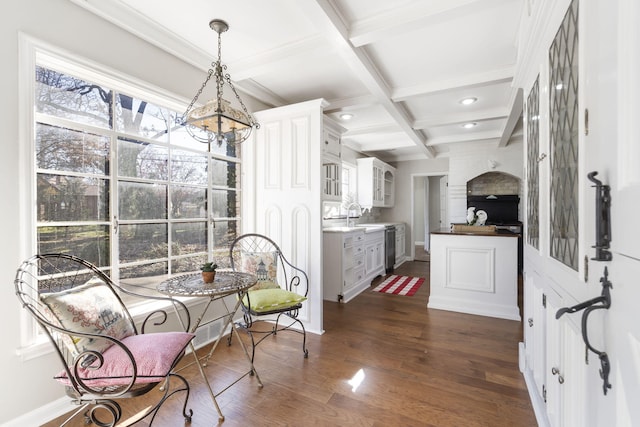 dining room featuring beam ceiling, sink, dark wood-type flooring, and coffered ceiling