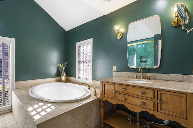 bathroom with tiled tub, a wealth of natural light, vanity, and lofted ceiling