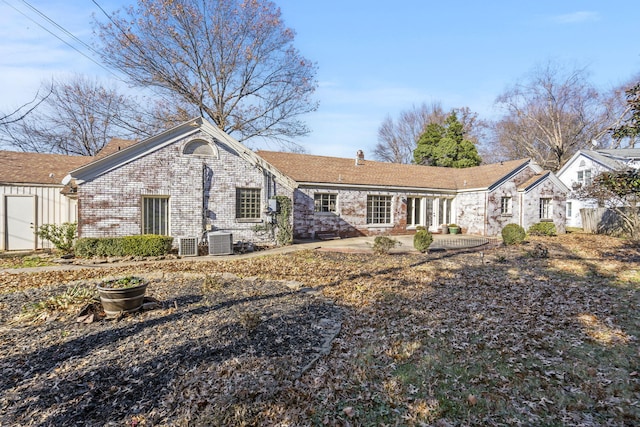 rear view of house featuring cooling unit and a patio