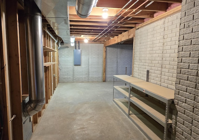 basement with brick wall and electric panel