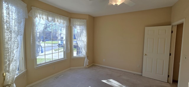 carpeted empty room with ceiling fan