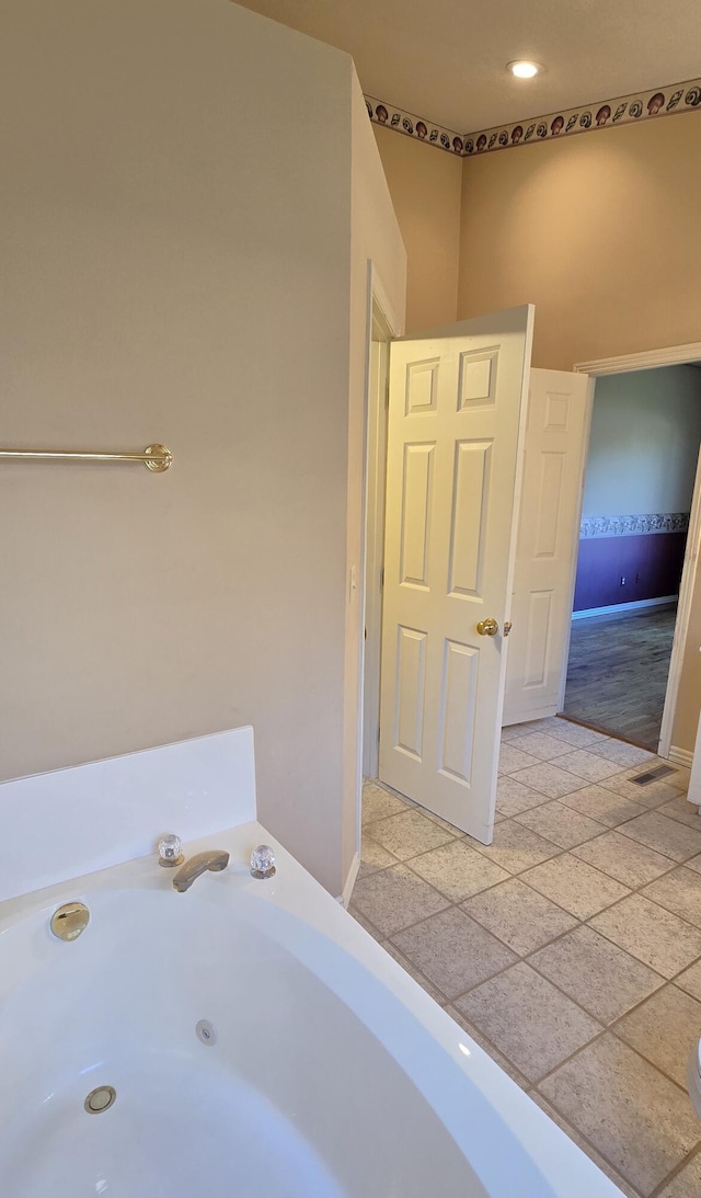 bathroom with hardwood / wood-style floors and a bathtub