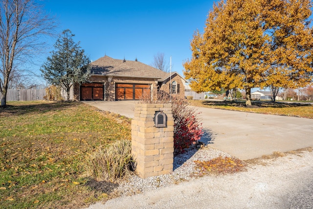 view of front of home featuring a garage and a front lawn