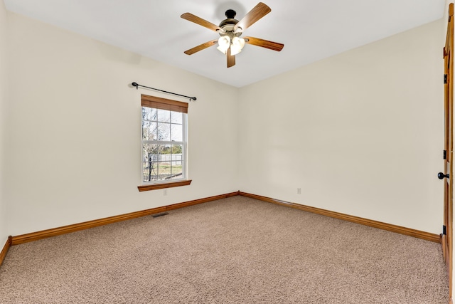 carpeted empty room featuring ceiling fan