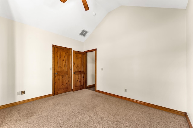 carpeted empty room with ceiling fan and lofted ceiling