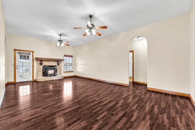 unfurnished living room featuring ceiling fan and dark hardwood / wood-style floors