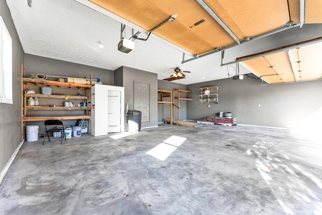 garage with ceiling fan and a garage door opener