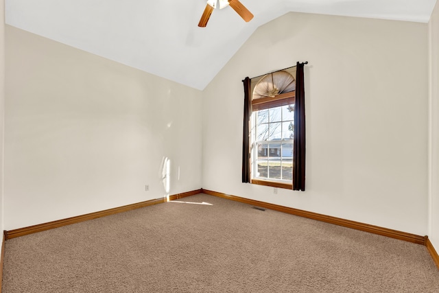 carpeted spare room with ceiling fan and lofted ceiling