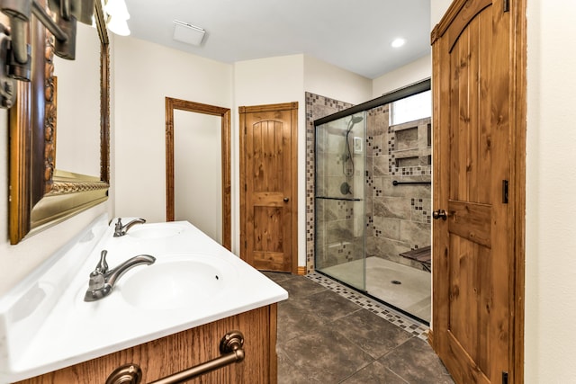 bathroom with tile patterned floors, vanity, and a shower with shower door