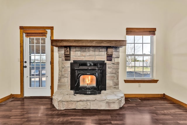 interior details with a wood stove and hardwood / wood-style flooring