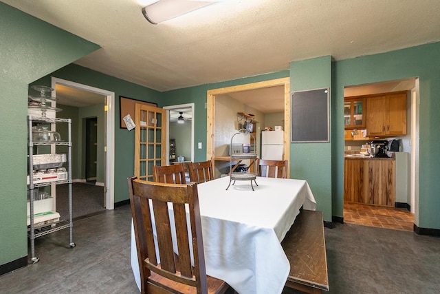 dining room with french doors and a textured ceiling