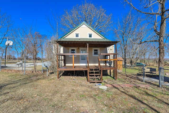 rear view of property featuring a porch