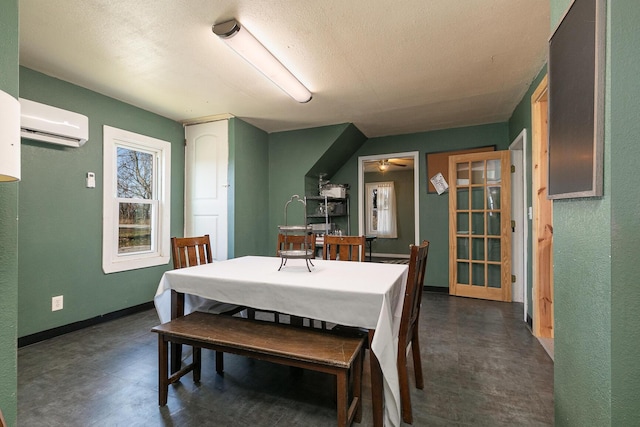 dining space featuring a textured ceiling, a wall mounted AC, and ceiling fan