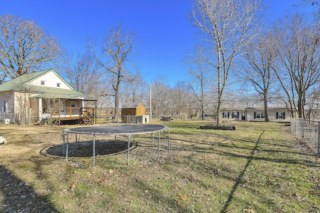 view of yard featuring a deck and a trampoline