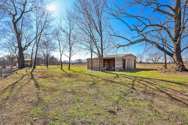 view of yard with an outbuilding and a rural view