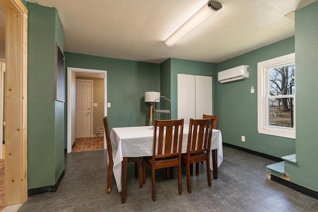 dining space featuring a textured ceiling and a wall mounted AC