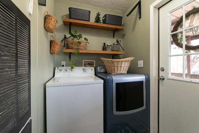 washroom with independent washer and dryer and a textured ceiling