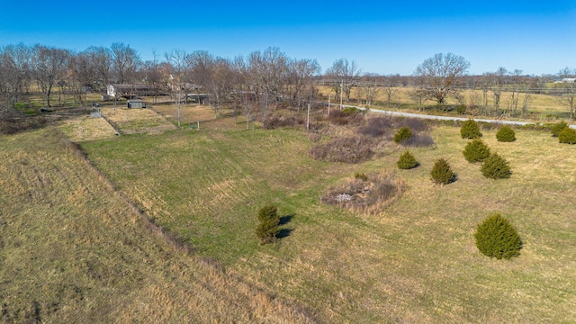 birds eye view of property with a rural view