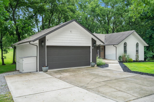 ranch-style house with a front lawn and a garage