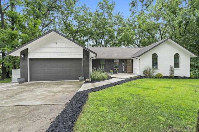 ranch-style house featuring a garage and a front lawn