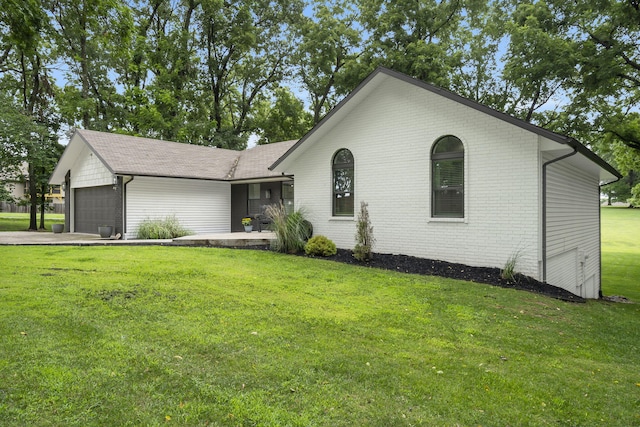 ranch-style house with a front yard and a garage