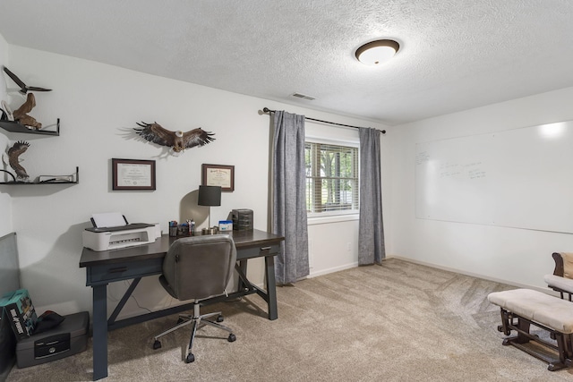 office area with light colored carpet and a textured ceiling