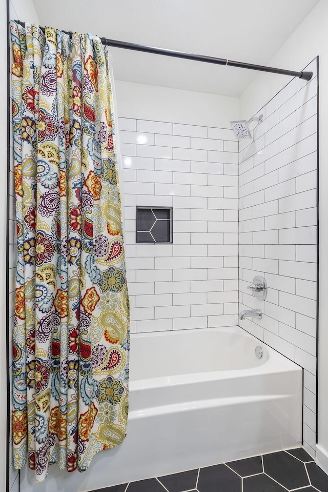 bathroom featuring tile patterned flooring and shower / bath combo