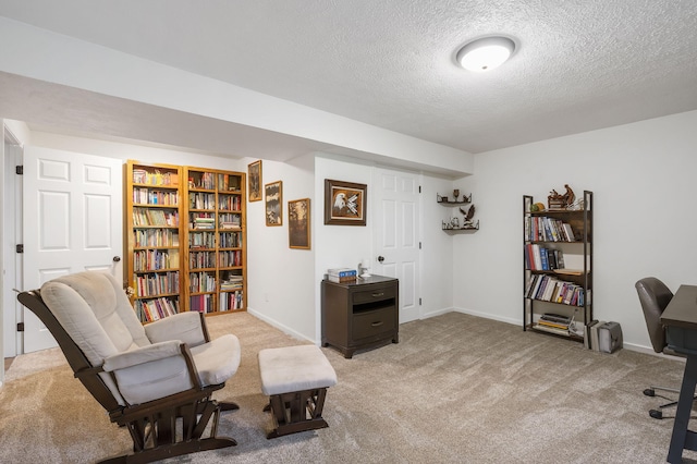 living area featuring light colored carpet and a textured ceiling