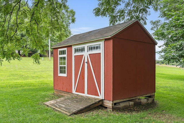 view of outbuilding featuring a yard