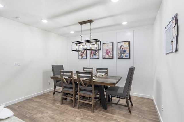 dining room featuring hardwood / wood-style flooring and a notable chandelier