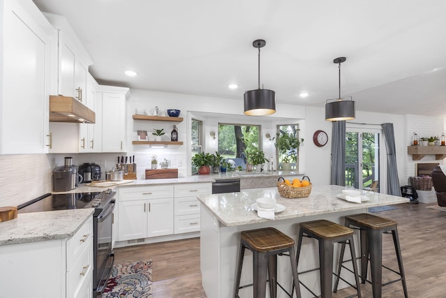 kitchen featuring black appliances, pendant lighting, white cabinets, and dark wood-type flooring