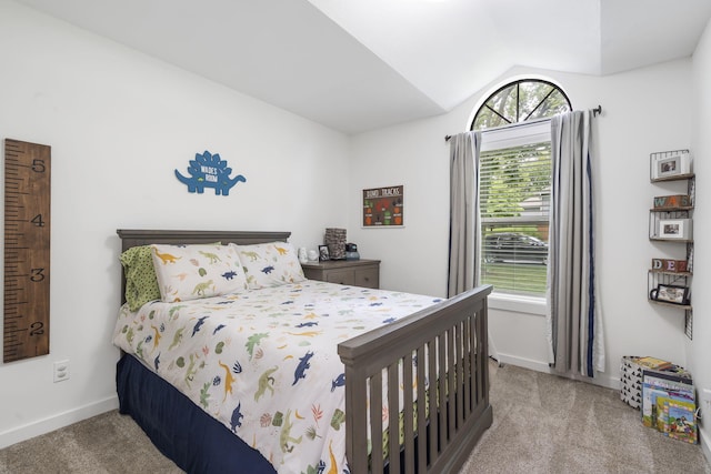 bedroom featuring light colored carpet, lofted ceiling, and multiple windows