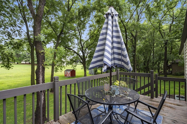 deck with a yard and a storage unit