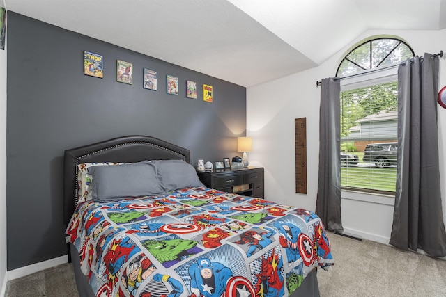 carpeted bedroom featuring lofted ceiling