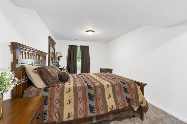 carpeted bedroom featuring a textured ceiling