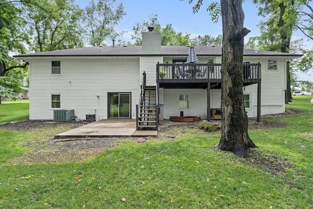 back of property with a lawn, a deck, a patio, and central AC