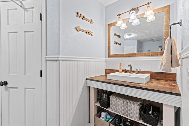 bathroom featuring vanity and a textured ceiling