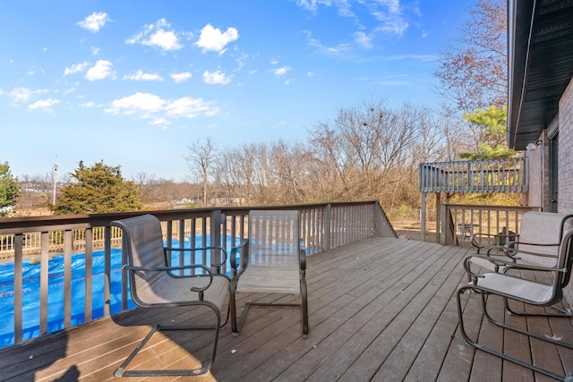 wooden deck with a covered pool