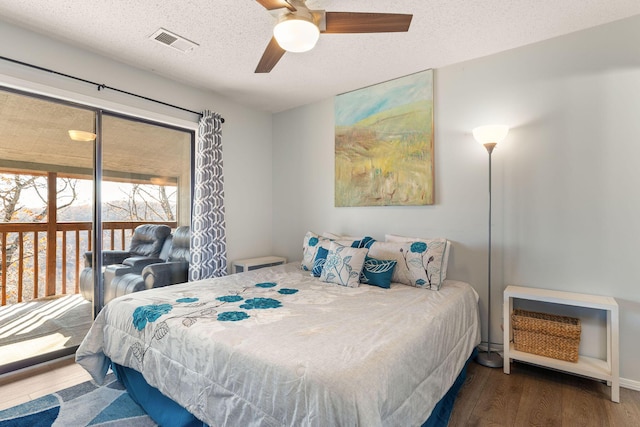 bedroom with ceiling fan, dark hardwood / wood-style flooring, and a textured ceiling