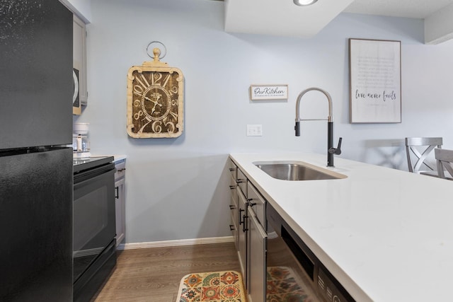526 Notch Ln Unit 10, Branson West, MO 65737 - kitchen with black appliances, wood finished floors, and light countertops