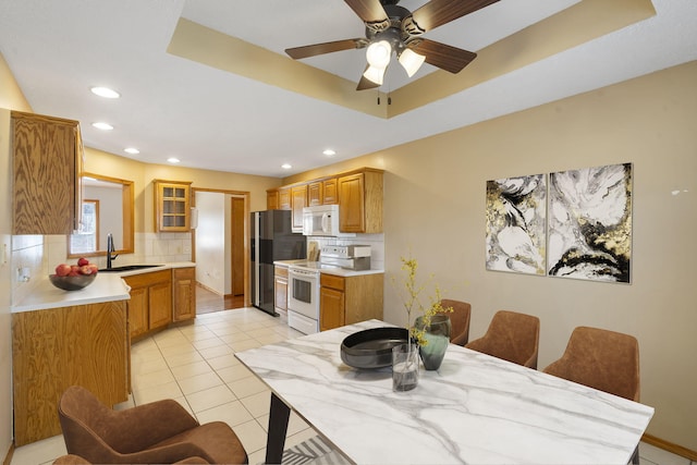 dining room with ceiling fan, sink, and light tile patterned floors