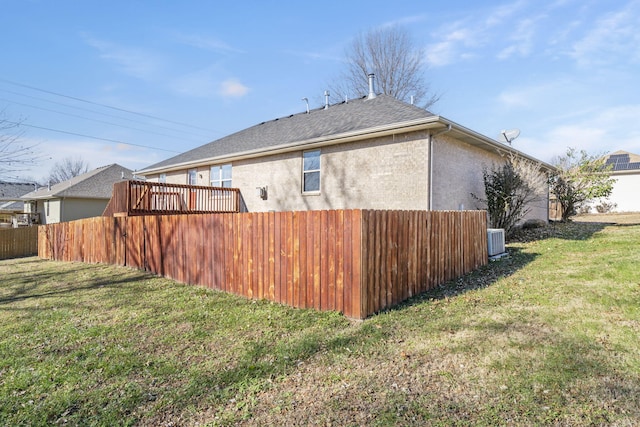 exterior space featuring a lawn and central AC unit