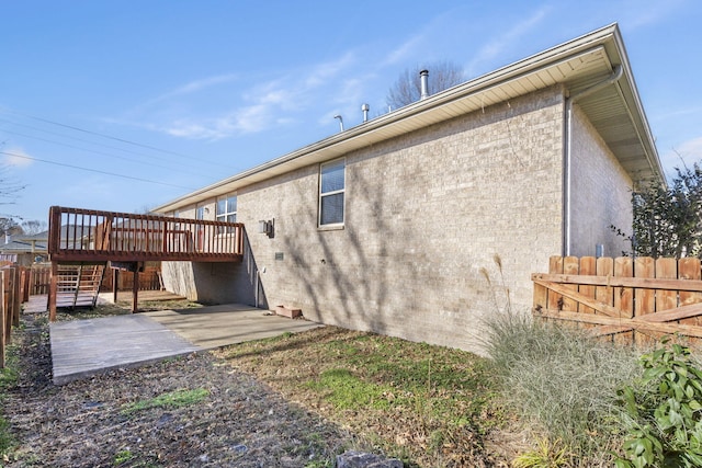 rear view of property with a patio area and a wooden deck