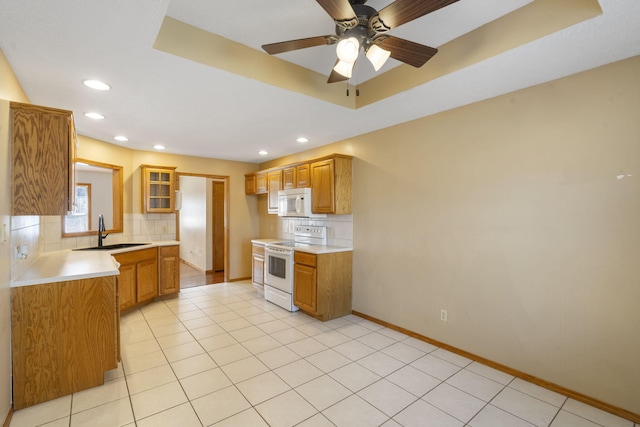 kitchen featuring white appliances, sink, ceiling fan, decorative backsplash, and light tile patterned floors