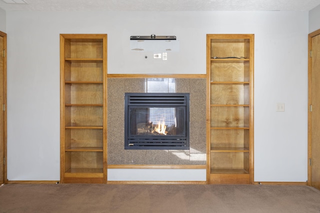 unfurnished living room with carpet and a textured ceiling