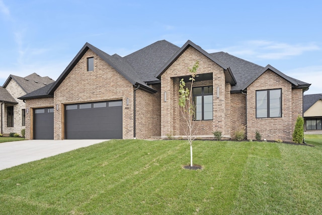 view of front of property with a garage and a front yard