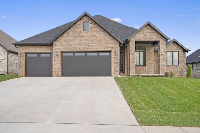 view of front facade with a front lawn and a garage