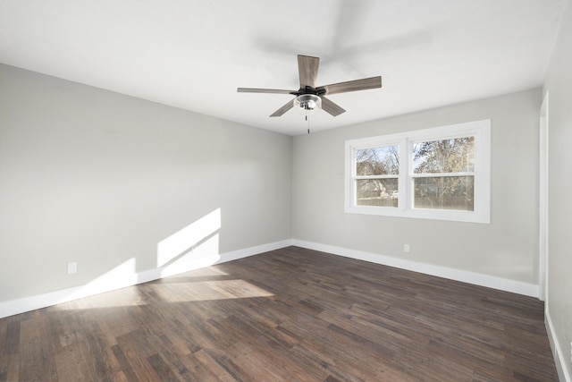 empty room with dark hardwood / wood-style floors and ceiling fan