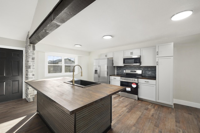 kitchen featuring sink, stainless steel appliances, dark hardwood / wood-style floors, backsplash, and white cabinets