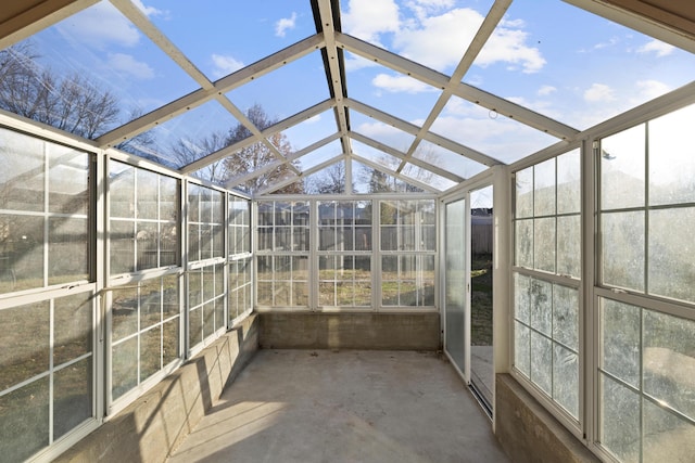 unfurnished sunroom featuring vaulted ceiling